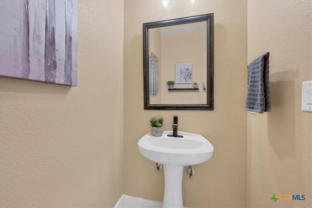 bathroom with a textured wall