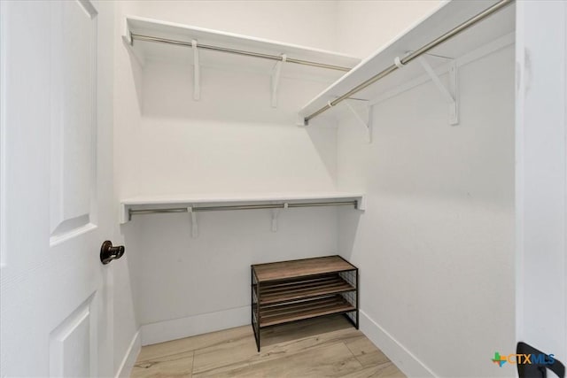 walk in closet featuring light wood finished floors