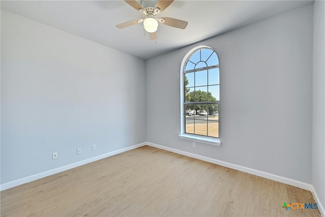 spare room featuring ceiling fan and light wood-type flooring