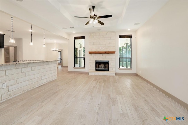 2892 Beulah Blvd, Belton, TX 76513 - unfurnished living room with light wood-type flooring, a raised ceiling, a ceiling fan, a fireplace, and baseboards