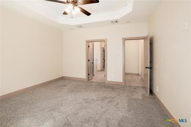 2892 Beulah Blvd, Belton, TX 76513 - unfurnished bedroom featuring light colored carpet, a raised ceiling, and ceiling fan