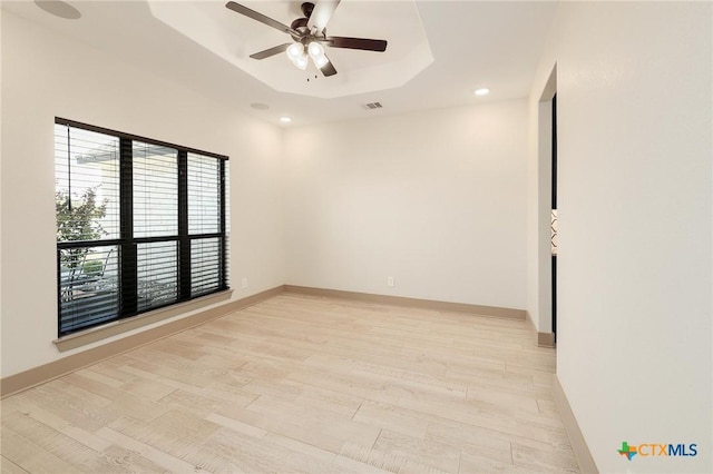 2892 Beulah Blvd, Belton, TX 76513 - empty room with ceiling fan, a raised ceiling, recessed lighting, light wood-style floors, and baseboards