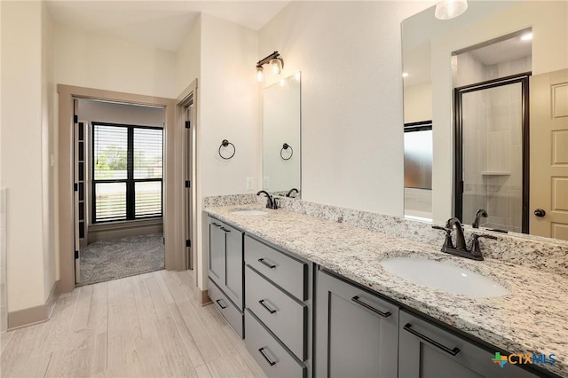 2892 Beulah Blvd, Belton, TX 76513 - full bathroom featuring wood finished floors, double vanity, and a shower with shower door