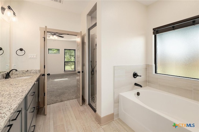 2892 Beulah Blvd, Belton, TX 76513 - full bathroom with vanity, ceiling fan, a bath, and a shower stall