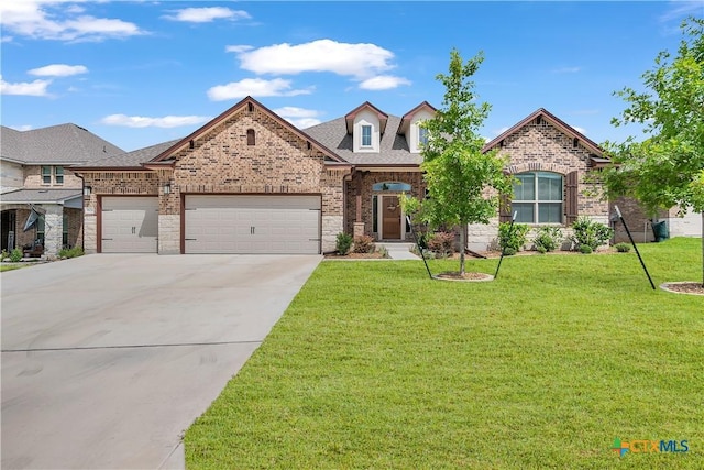 view of front facade with a garage and a front lawn