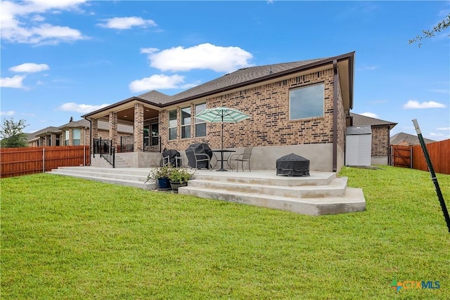 back of house with a patio, a yard, and an outdoor fire pit