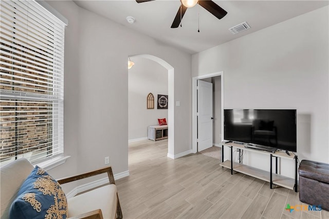 living room with ceiling fan and light wood-type flooring