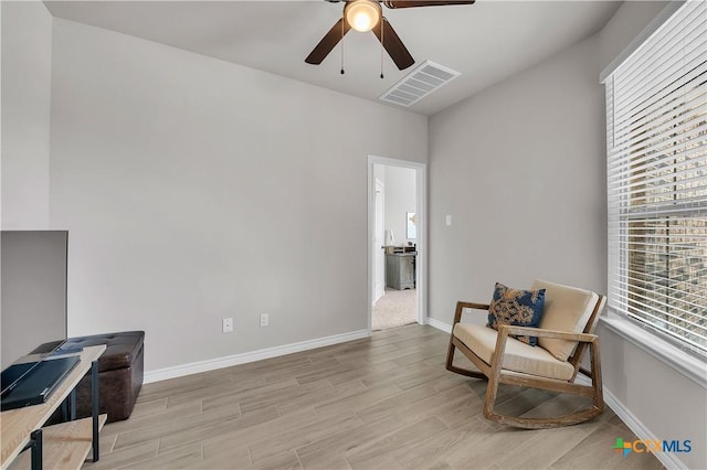 living area featuring ceiling fan and light wood-type flooring