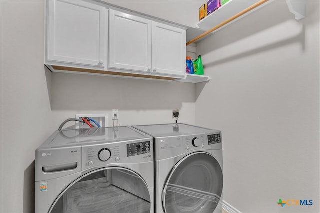 laundry room with cabinets and separate washer and dryer