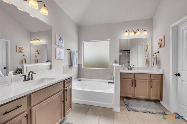 bathroom featuring lofted ceiling, vanity, tile patterned floors, and plus walk in shower