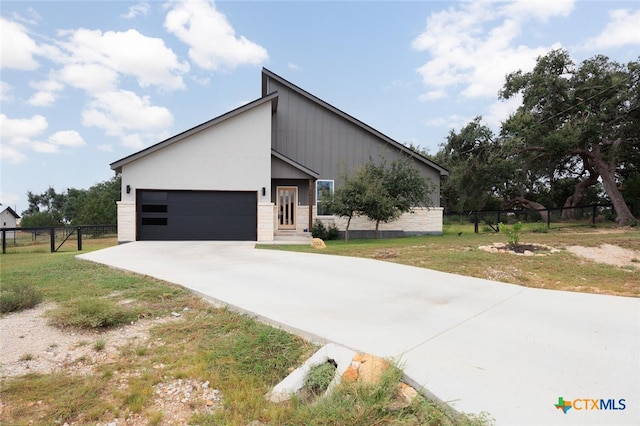 view of front of house with a garage and a front lawn