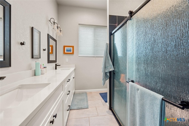 bathroom featuring vanity, a shower with shower door, and tile patterned flooring