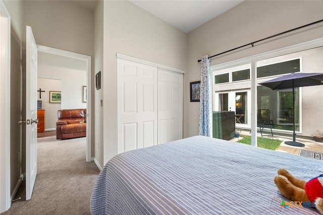 carpeted bedroom featuring access to outside and a closet