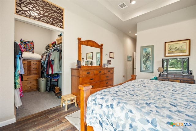 bedroom featuring dark wood-type flooring and a closet