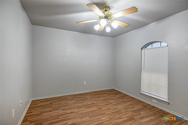 spare room with ceiling fan and wood-type flooring