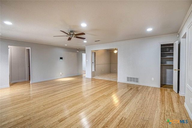 unfurnished room featuring ceiling fan, light hardwood / wood-style flooring, a textured ceiling, and ornamental molding