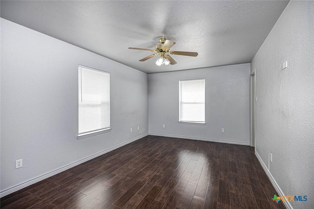 unfurnished room with a textured ceiling, dark hardwood / wood-style floors, and ceiling fan