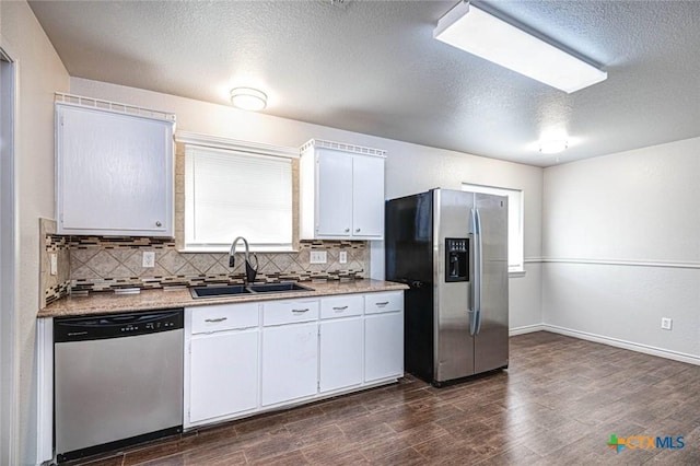 kitchen with white cabinetry, sink, stainless steel appliances, dark hardwood / wood-style flooring, and a textured ceiling