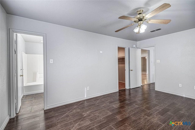 unfurnished room with ceiling fan and dark hardwood / wood-style flooring