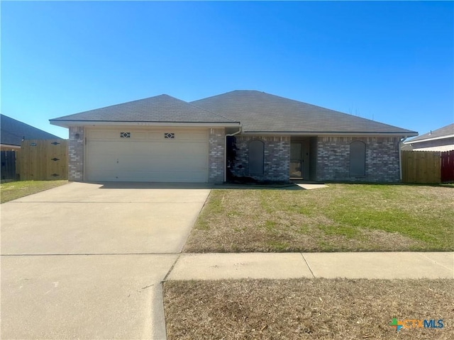 ranch-style house with a garage and a front yard