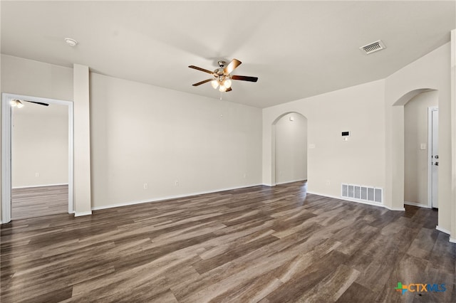 2503 Pintail Loop, Copperas Cove, TX 76522 - unfurnished living room with arched walkways, a ceiling fan, and dark wood finished floors