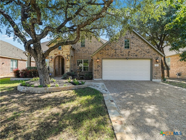 535 Mission Hill Run, New Braunfels, TX 78132 - english style home with driveway, brick siding, and a garage