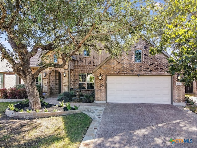 535 Mission Hill Run, New Braunfels, TX 78132 - view of front of house with driveway, brick siding, and a garage