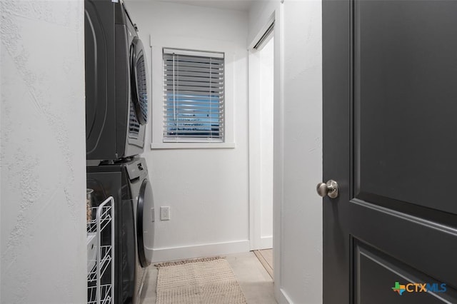 119 W Crockett St, Luling, TX 78648 - laundry area featuring stacked washer and clothes dryer and baseboards