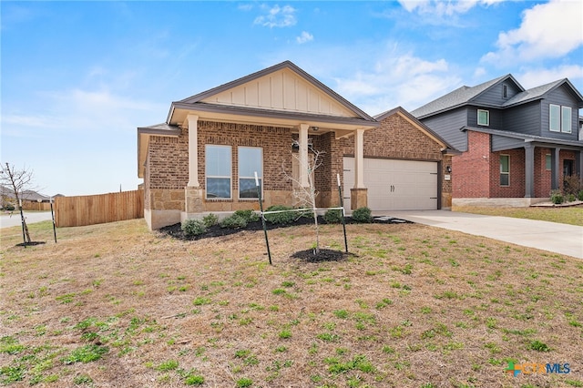 view of front of property featuring fence, concrete driveway, a garage, board and batten siding, and brick siding