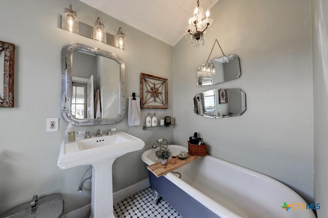 full bathroom featuring a soaking tub, baseboards, and vaulted ceiling