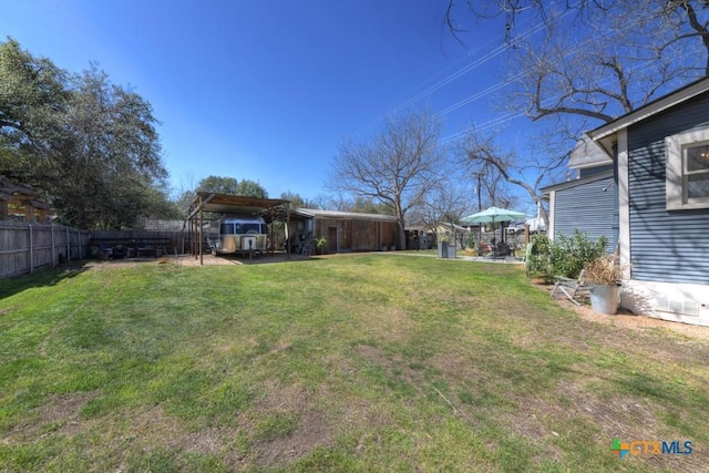 view of yard featuring a carport and fence