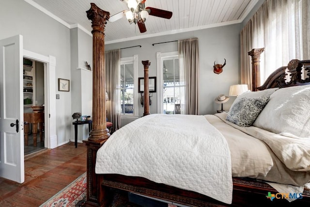 bedroom featuring wooden ceiling, crown molding, baseboards, and wood-type flooring