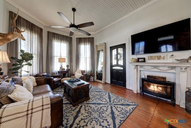 living room with plenty of natural light, ornamental molding, ceiling fan, and hardwood / wood-style floors