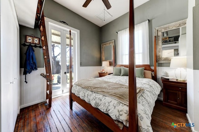 bedroom featuring hardwood / wood-style floors, access to exterior, french doors, and a wainscoted wall