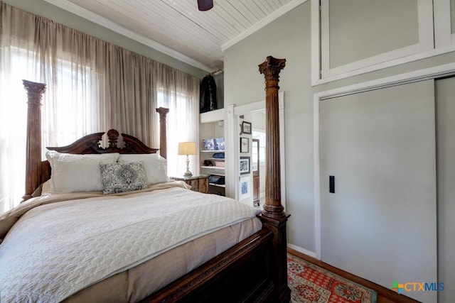 bedroom with a ceiling fan, lofted ceiling, wood ceiling, and ornamental molding