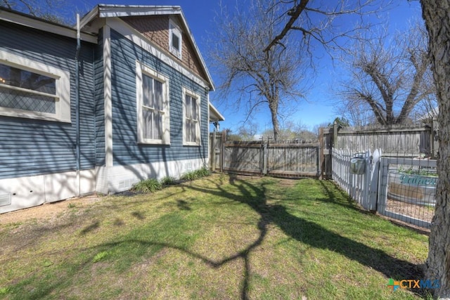 view of yard with a fenced backyard