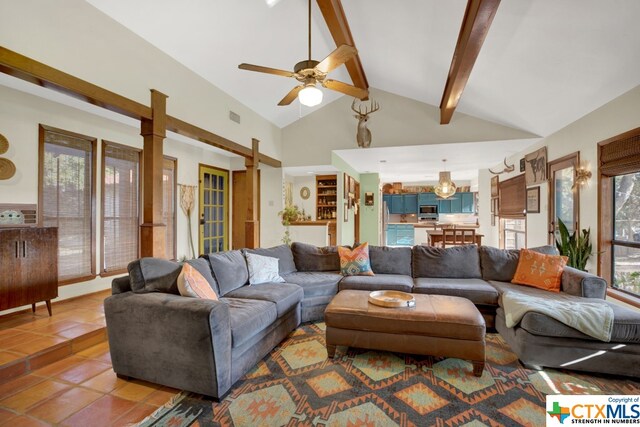 tiled living room with ceiling fan, beamed ceiling, and high vaulted ceiling