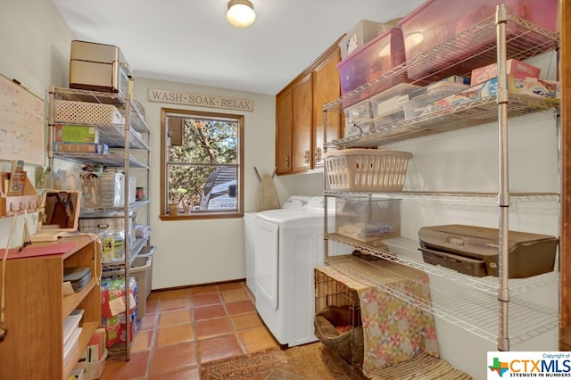 washroom with cabinets, washer / dryer, and light tile patterned flooring