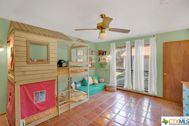 tiled bedroom featuring ceiling fan