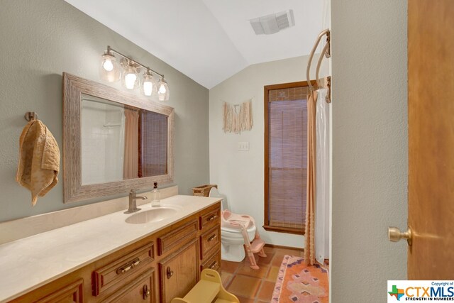 bathroom featuring toilet, vaulted ceiling, tile patterned flooring, a shower with curtain, and vanity