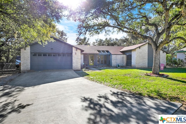 ranch-style home with a front yard and a garage