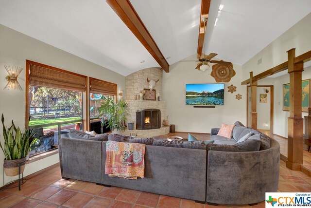 living room with a fireplace, vaulted ceiling with beams, and ceiling fan