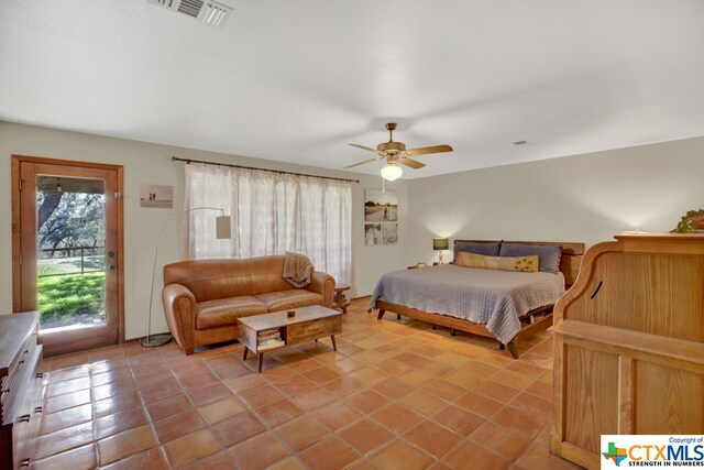 tiled bedroom featuring ceiling fan and access to exterior