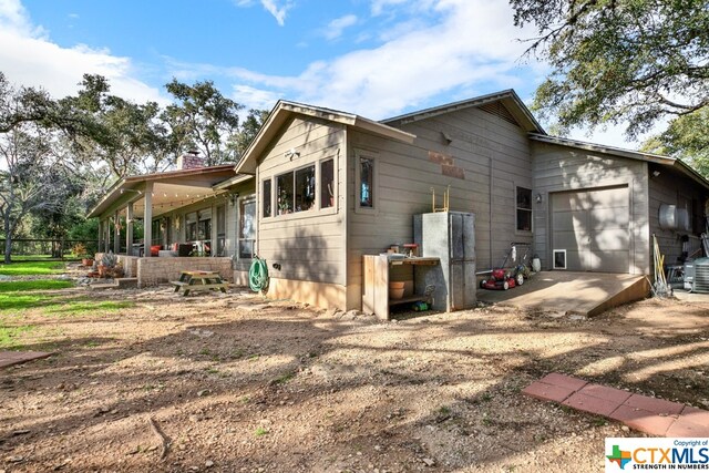 rear view of house with a garage