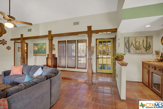 living room featuring ceiling fan, tile patterned floors, and sink