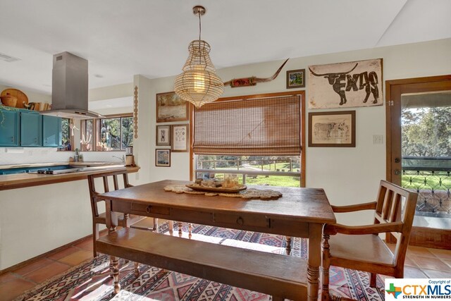 dining area with light tile patterned flooring and a healthy amount of sunlight