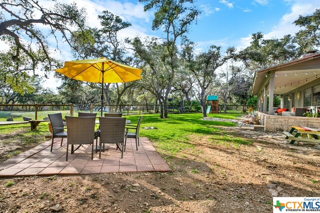 view of yard featuring a playground and a patio area