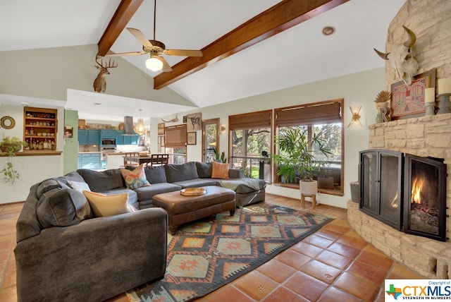 tiled living room featuring a stone fireplace, high vaulted ceiling, beamed ceiling, and ceiling fan