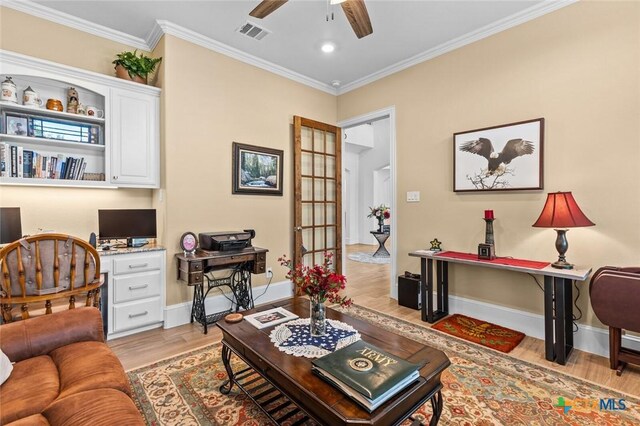 1605 Altavista Loop, Temple, TX 76502 - living room with an office area, light wood-style floors, a ceiling fan, crown molding, and baseboards