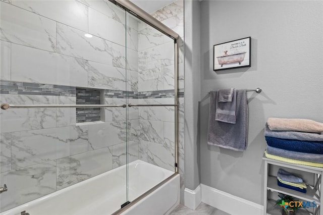 1605 Altavista Loop, Temple, TX 76502 - full bathroom featuring baseboards, enclosed tub / shower combo, and marble finish flooring